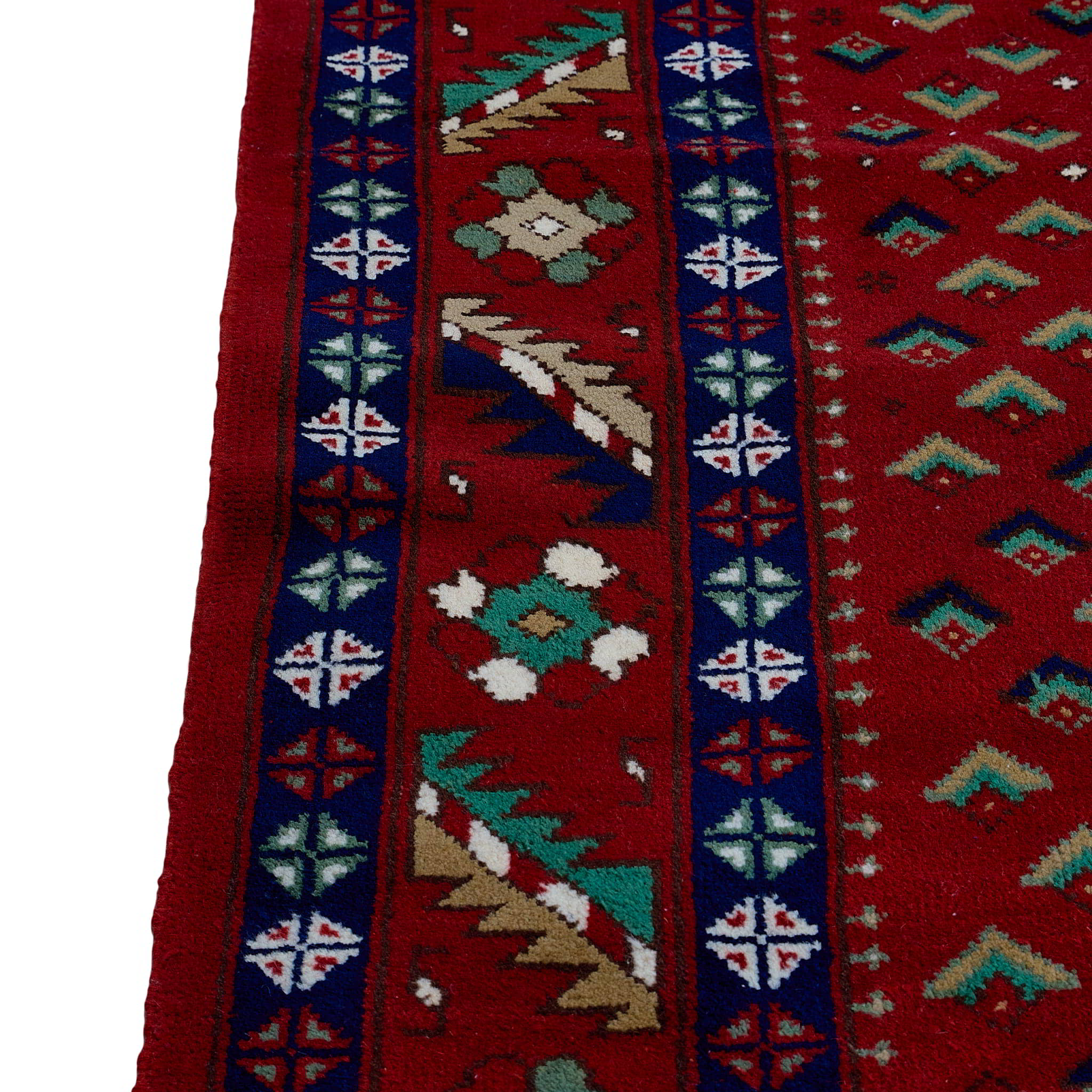 rug in deep red wool with triple diamond motif, demonstrating handwoven rug craftsmanship.