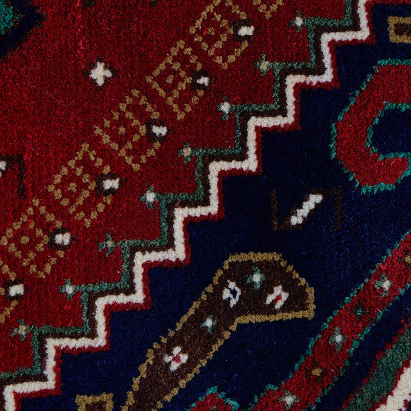 rug in deep red wool with triple diamond motif, demonstrating handwoven rug craftsmanship.