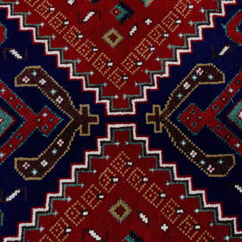 rug in deep red wool with triple diamond motif, demonstrating handwoven rug craftsmanship.