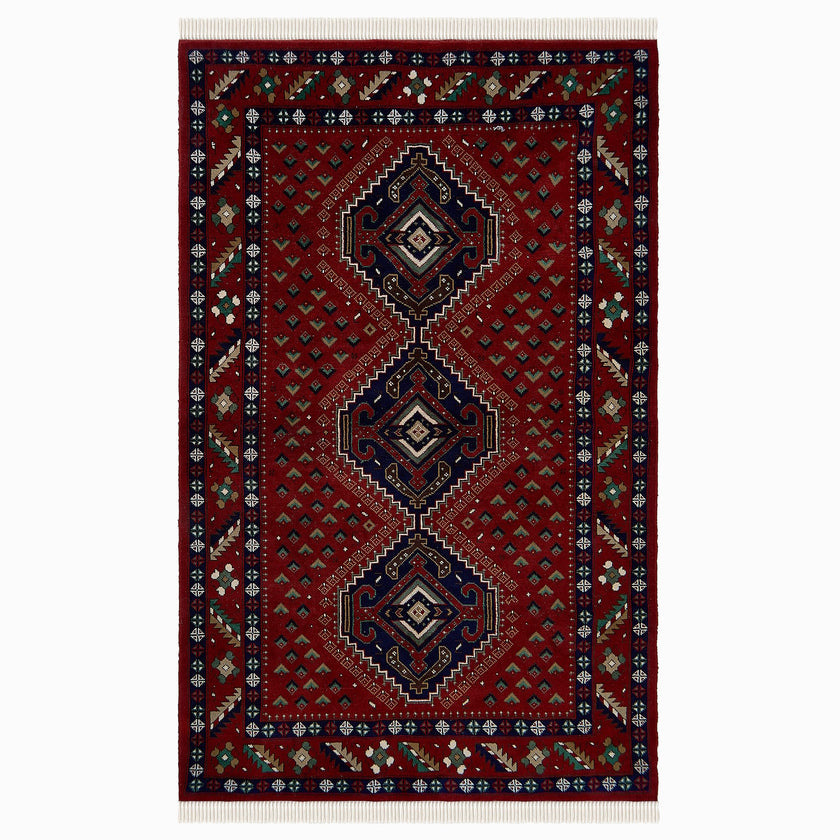 rug in deep red wool with triple diamond motif, demonstrating handwoven rug craftsmanship.