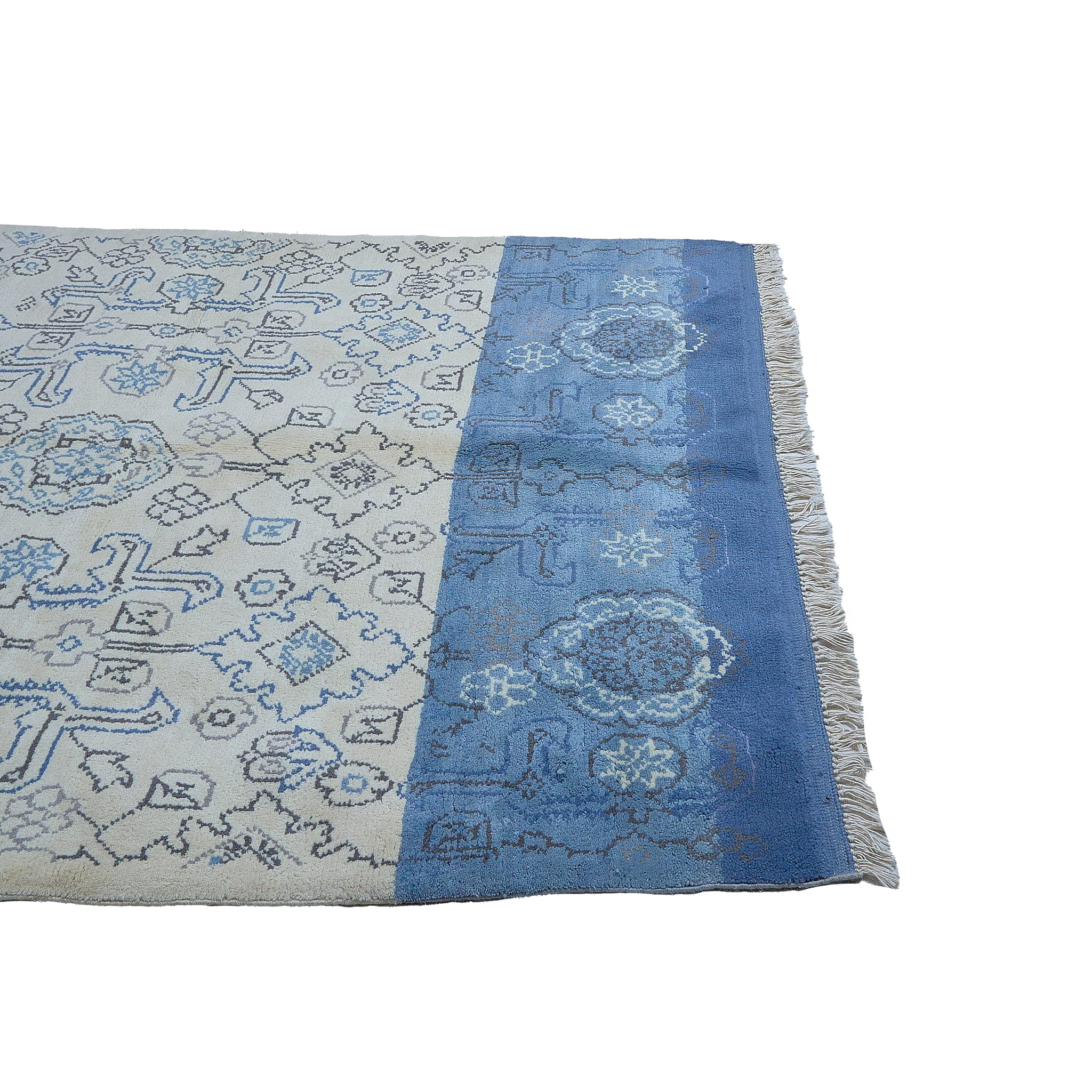 rug in beige wool with tilework/arabesque motif, demonstrating handwoven rug craftsmanship.