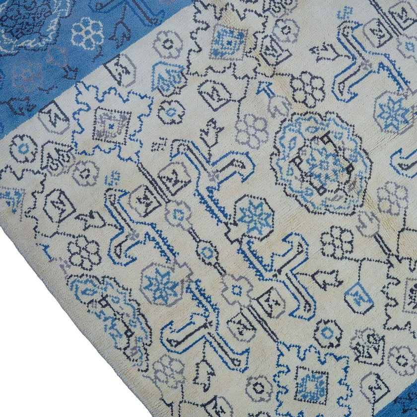 rug in beige wool with tilework/arabesque motif, demonstrating handwoven rug craftsmanship.