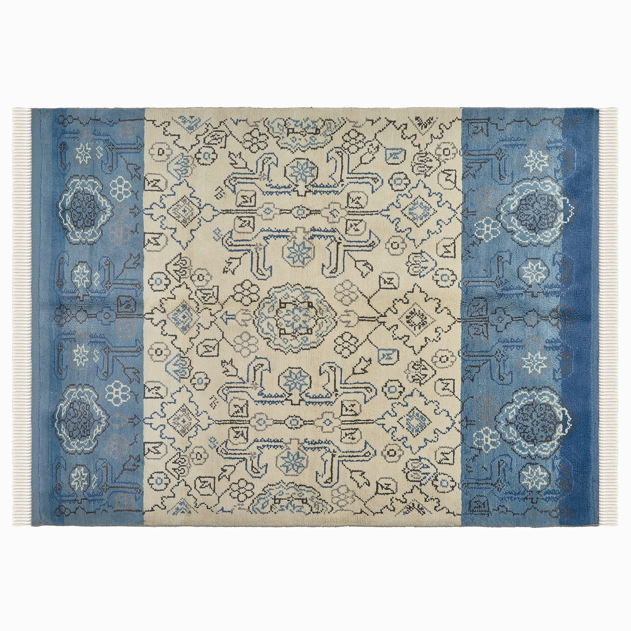 rug in beige wool with tilework/arabesque motif, demonstrating handwoven rug craftsmanship.