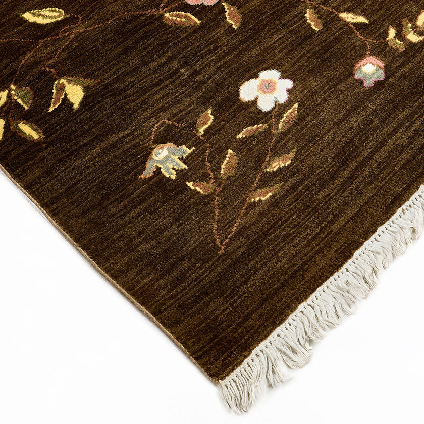 rug in brown wool with vinework floral motif, demonstrating handwoven rug craftsmanship.