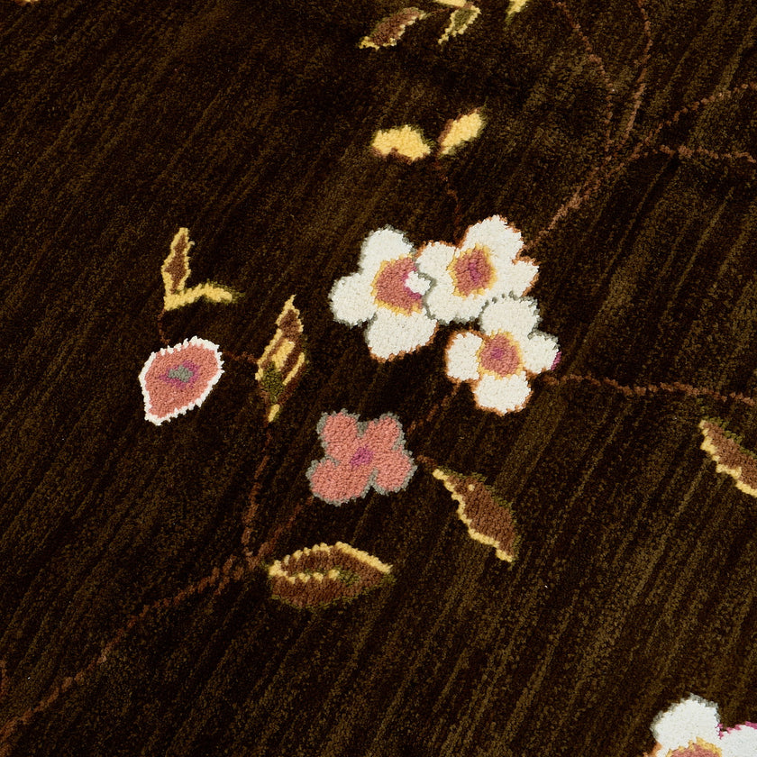 rug in brown wool with vinework floral motif, demonstrating handwoven rug craftsmanship.