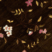 rug in brown wool with vinework floral motif, demonstrating handwoven rug craftsmanship.