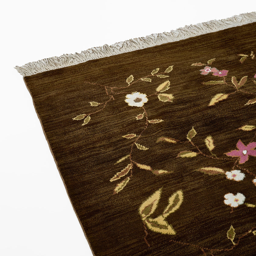 rug in brown wool with vinework floral motif, demonstrating handwoven rug craftsmanship.