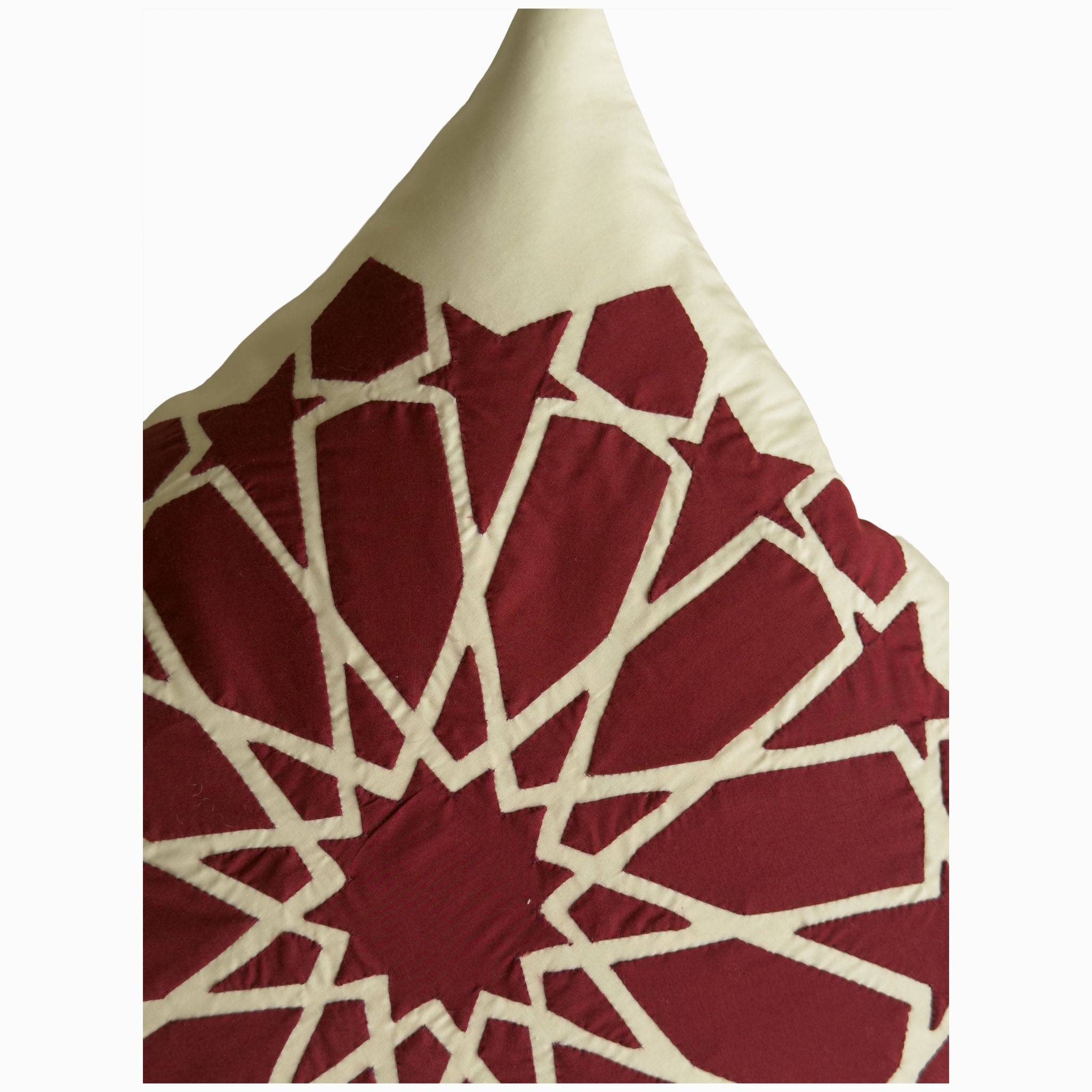 Cushion in burgundy polycotton with Najmi star geometry, demonstrating Khayamiya craftsmanship.