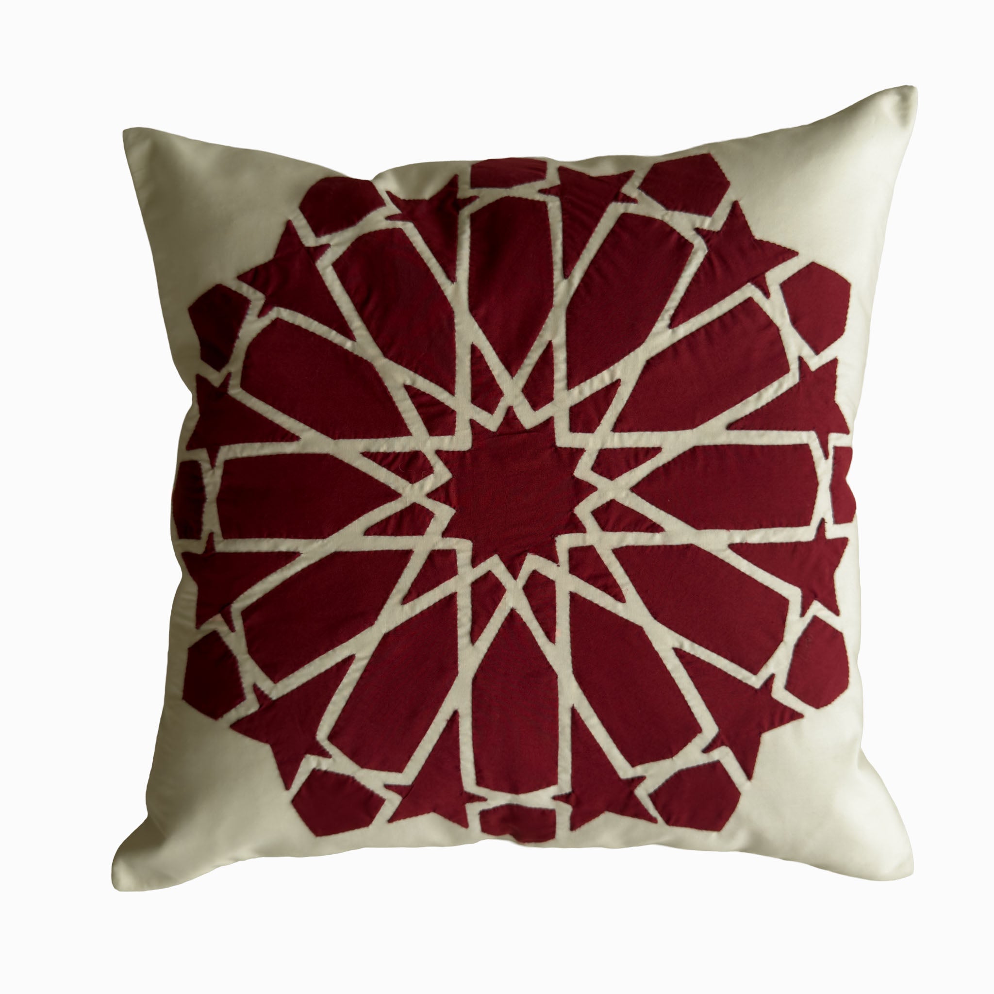 Cushion in burgundy polycotton with Najmi star geometry, demonstrating Khayamiya craftsmanship.