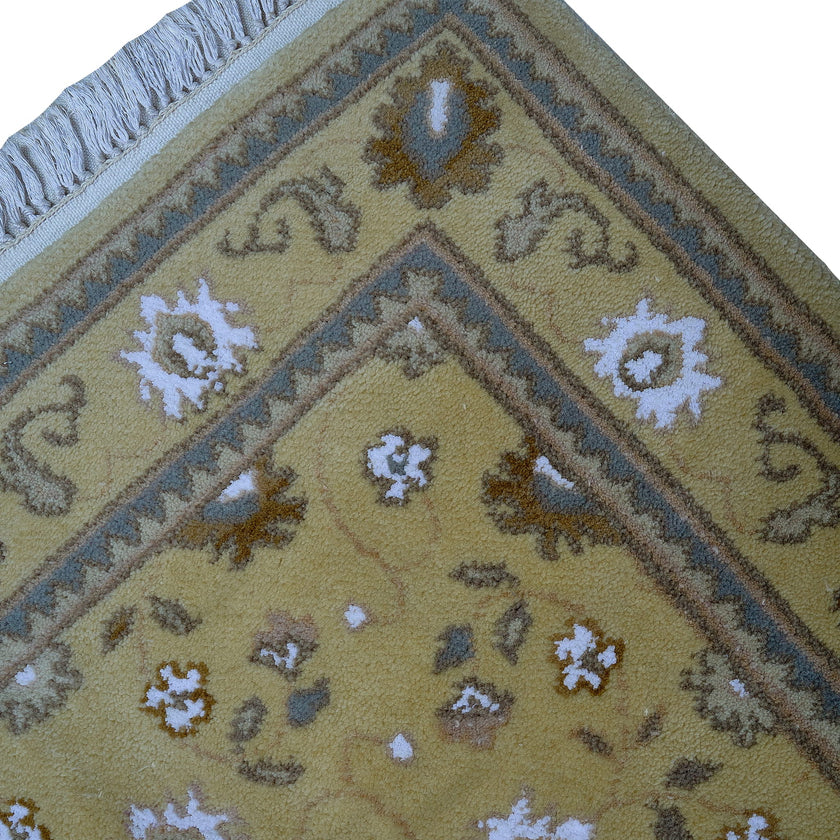 rug in camel wool–silk blend with floral field motif, demonstrating handwoven rug craftsmanship.