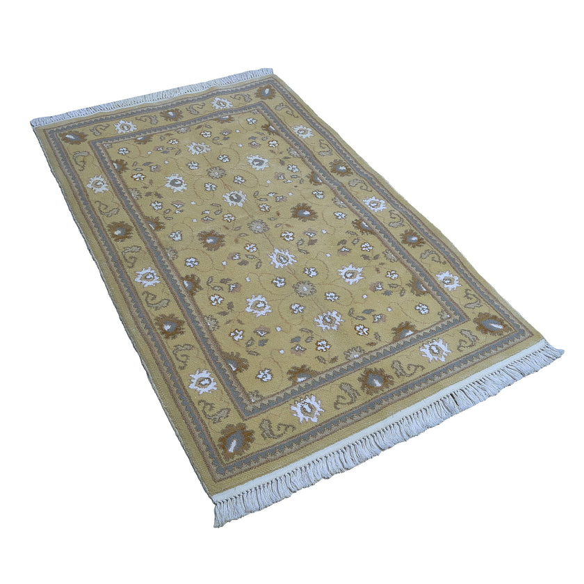 rug in camel wool–silk blend with floral field motif, demonstrating handwoven rug craftsmanship.