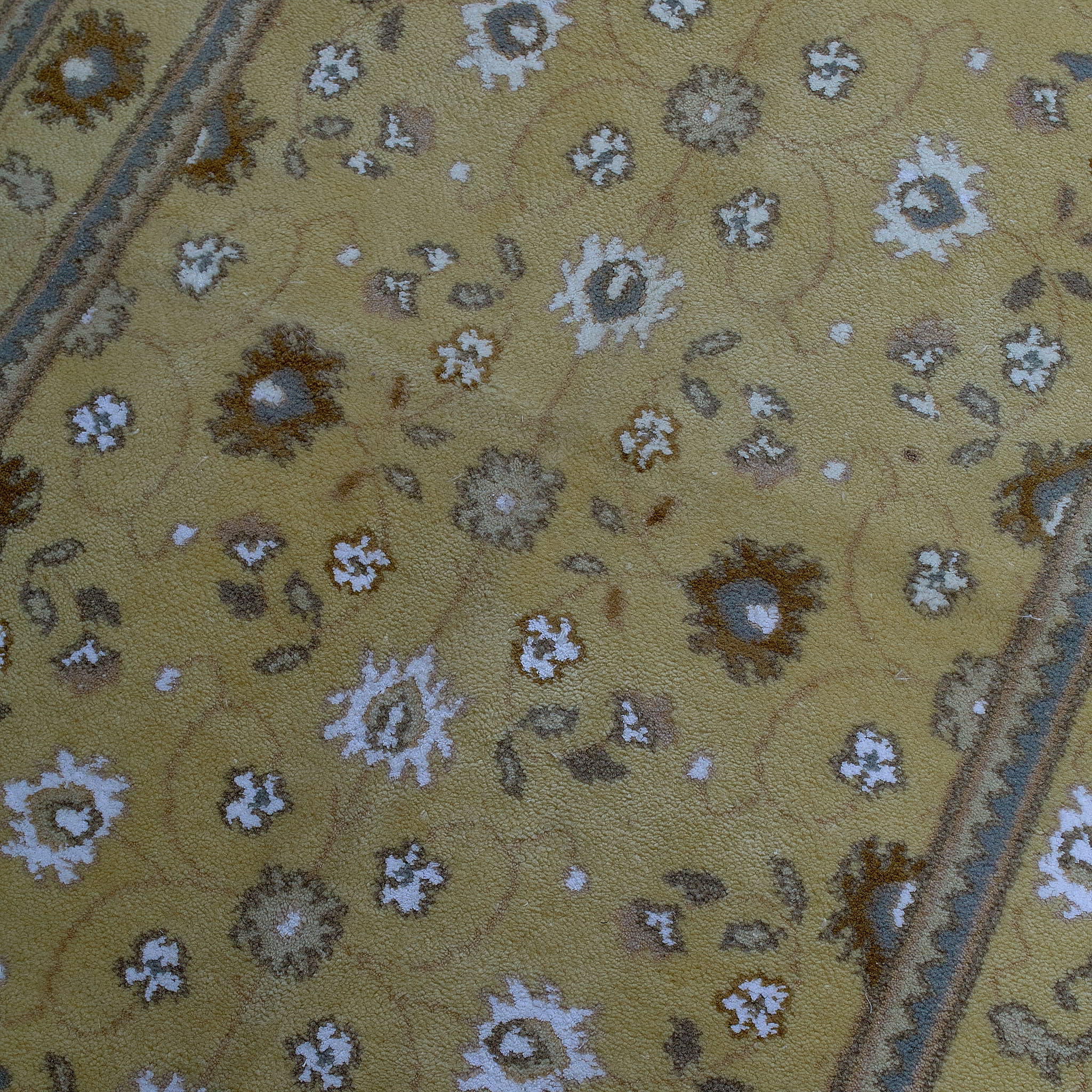 rug in camel wool–silk blend with floral field motif, demonstrating handwoven rug craftsmanship.