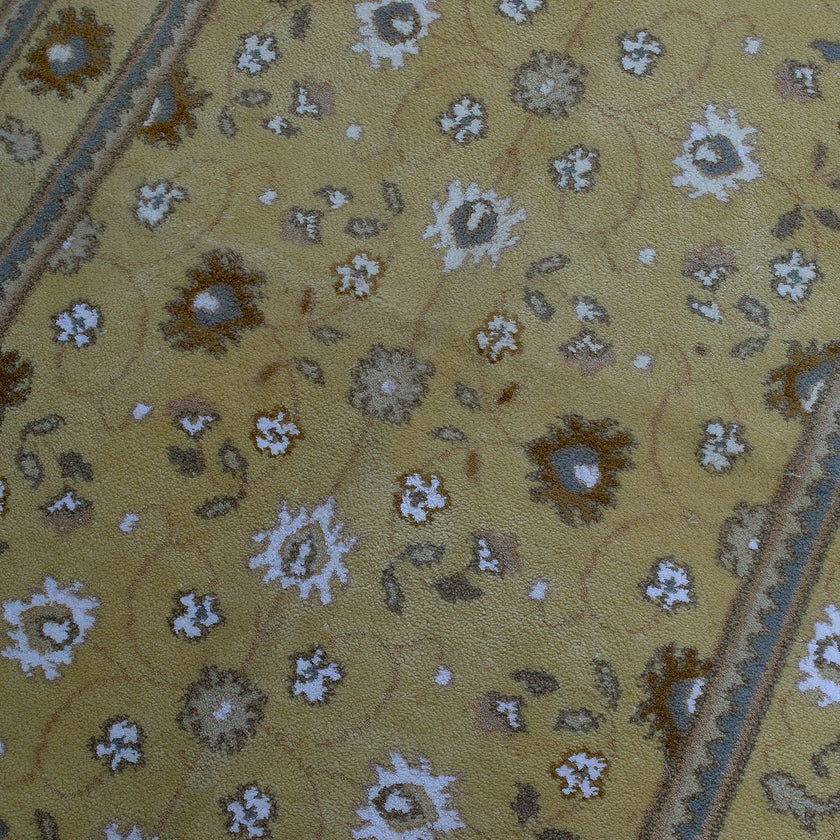 rug in camel wool–silk blend with floral field motif, demonstrating handwoven rug craftsmanship.