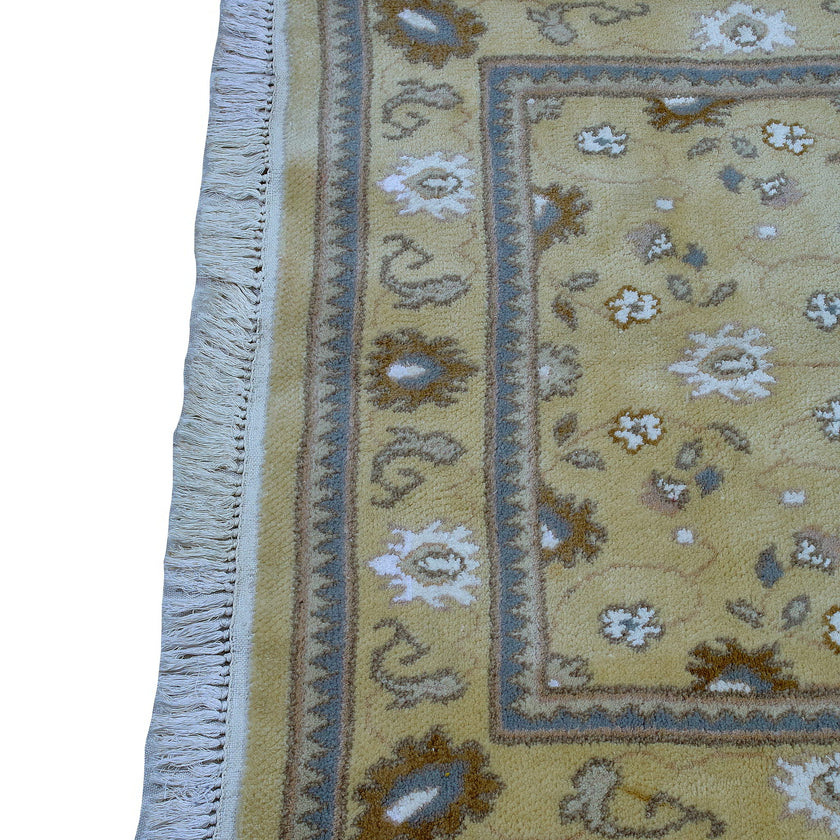 rug in camel wool–silk blend with floral field motif, demonstrating handwoven rug craftsmanship.