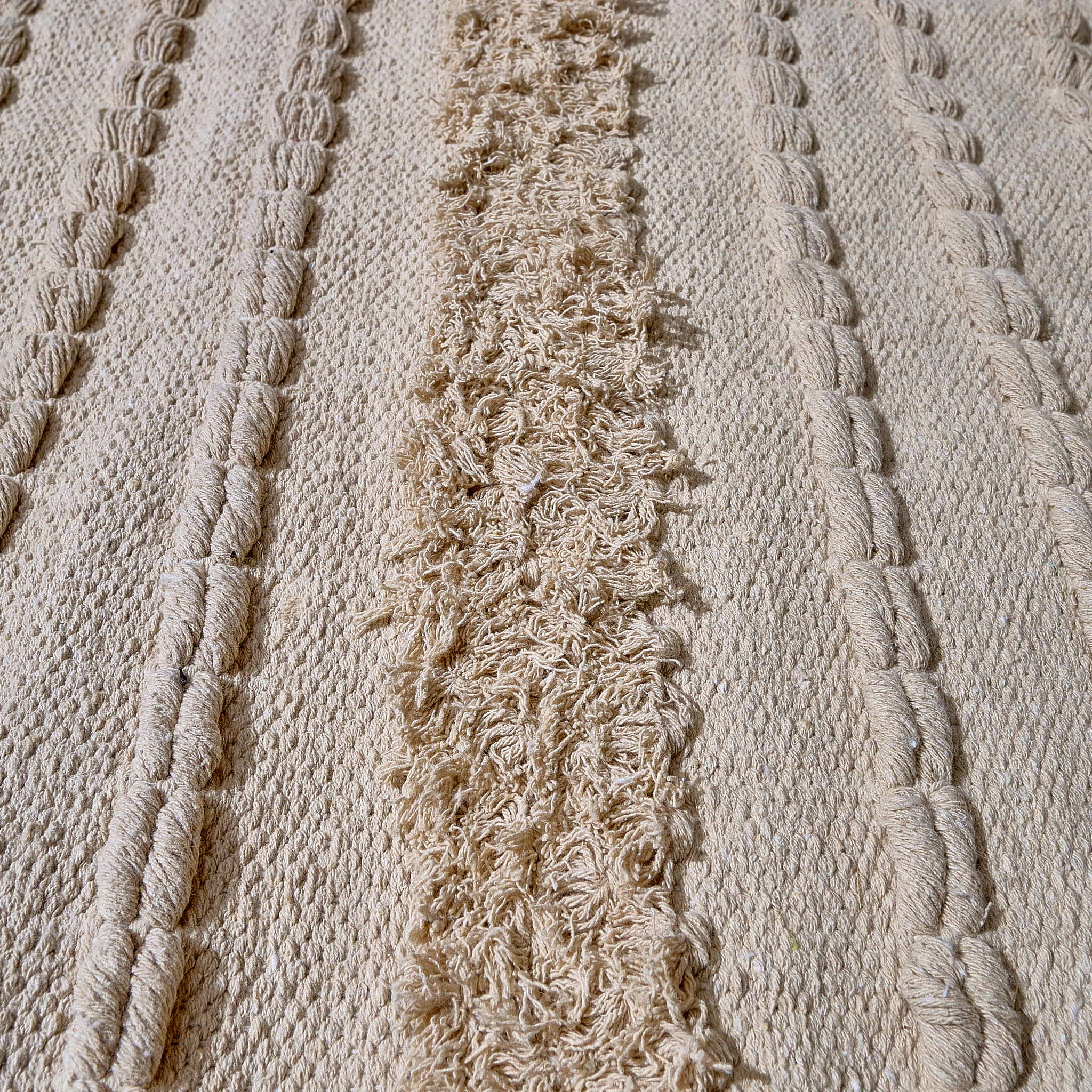 kilim in cream cotton with textured stripe motif, demonstrating kilim craftsmanship.