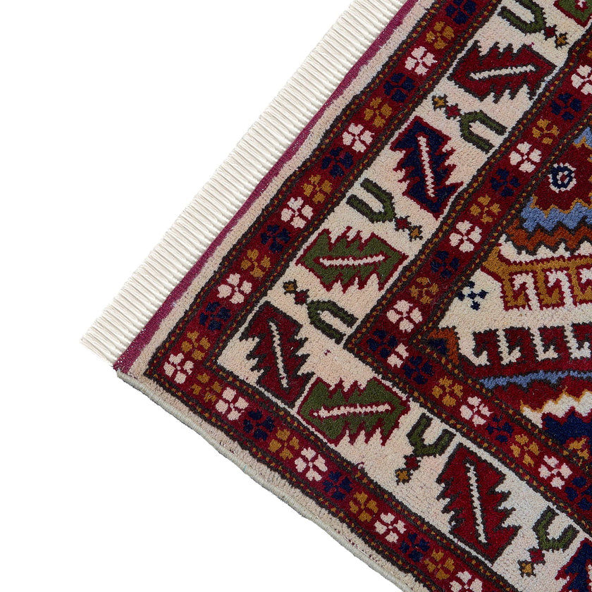 rug in red wool with geometric lattice motif, demonstrating handwoven rug craftsmanship.