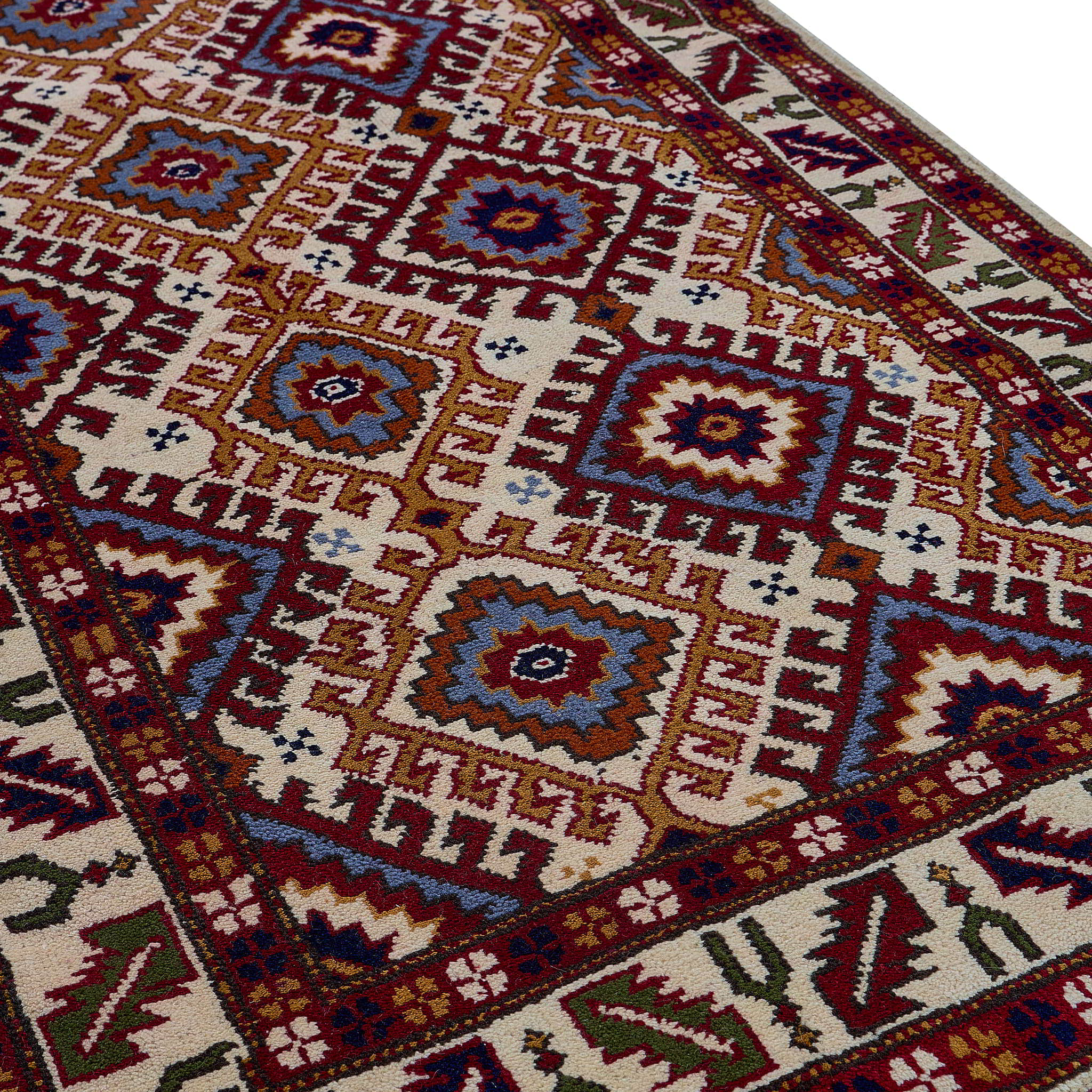 rug in red wool with geometric lattice motif, demonstrating handwoven rug craftsmanship.