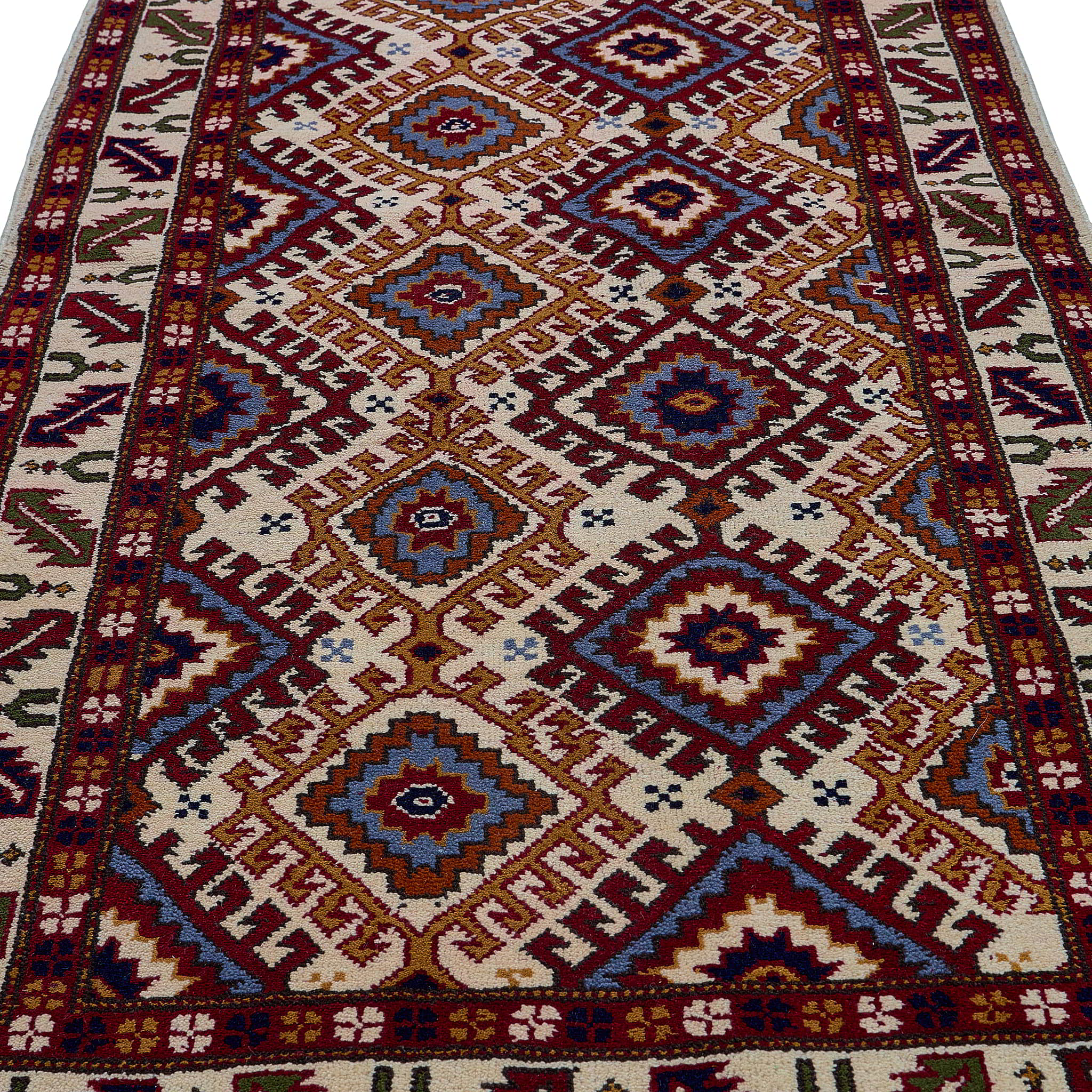 rug in red wool with geometric lattice motif, demonstrating handwoven rug craftsmanship.