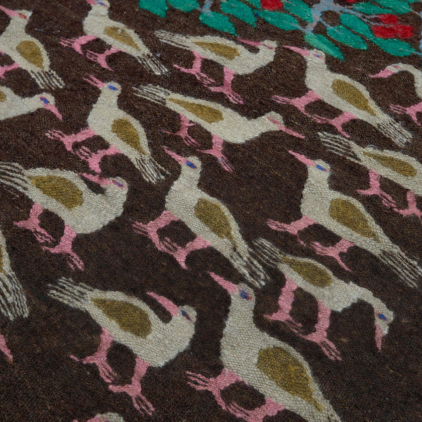 rug in deep red wool with floral medallion motif, demonstrating handwoven rug craftsmanship.