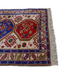 rug in deep red wool with triple medallion motif, demonstrating handwoven rug craftsmanship.