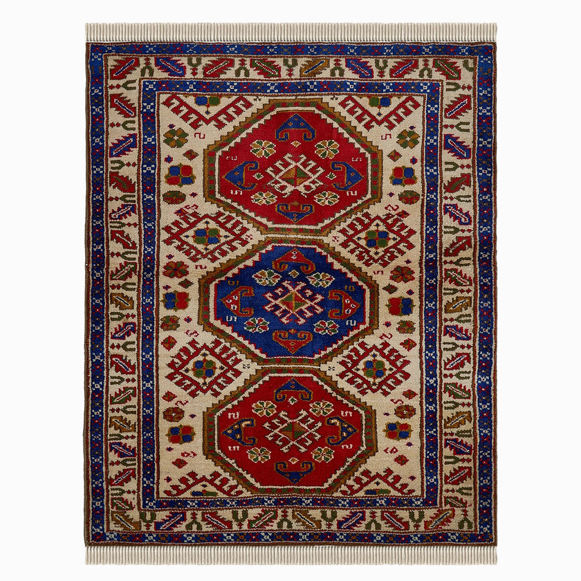 rug in deep red wool with triple medallion motif, demonstrating handwoven rug craftsmanship.