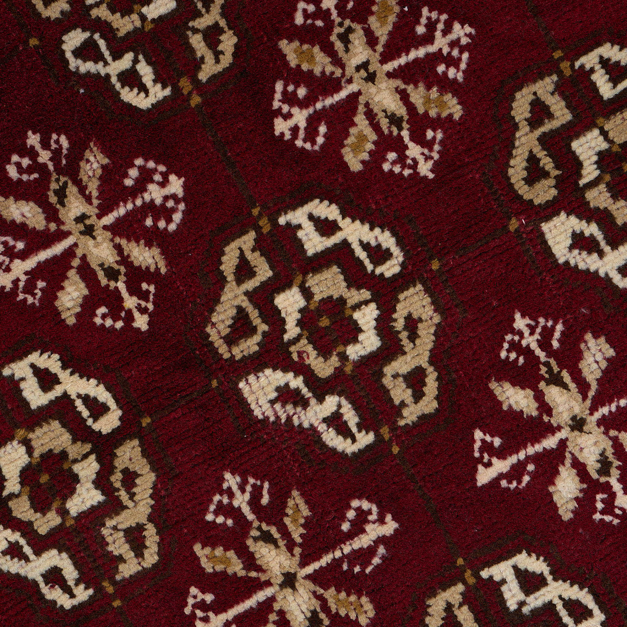 rug in deep red wool with rosette field motif, demonstrating handwoven rug craftsmanship.