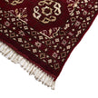 rug in deep red wool with rosette field motif, demonstrating handwoven rug craftsmanship.