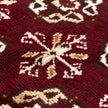 rug in deep red wool with rosette field motif, demonstrating kilim craftsmanship.