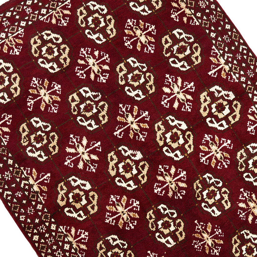 rug in deep red wool with rosette field motif, demonstrating kilim craftsmanship.