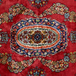 rug in deep red silk with oval floral medallion motif, demonstrating handwoven rug craftsmanship.