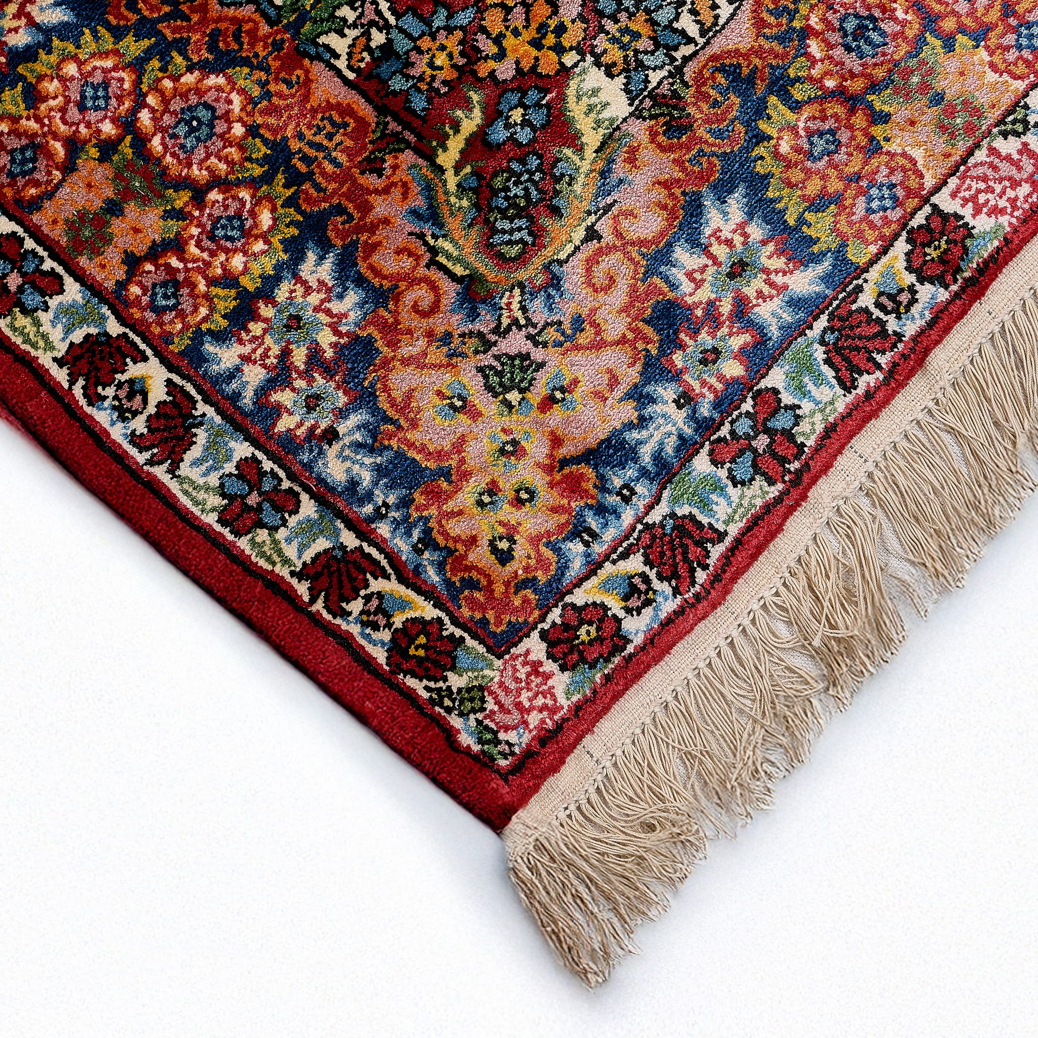 rug in deep red silk with oval floral medallion motif, demonstrating handwoven rug craftsmanship.