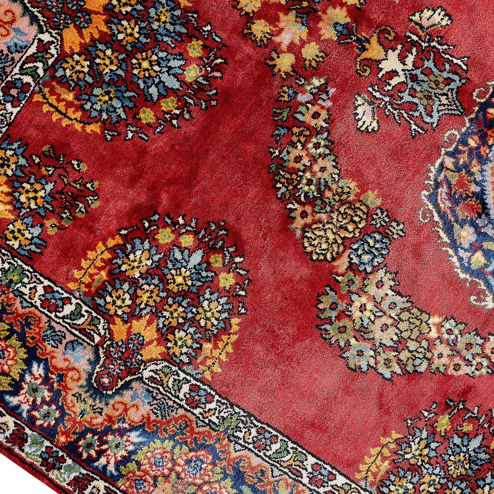 rug in deep red silk with oval floral medallion motif, demonstrating handwoven rug craftsmanship.