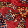 rug in deep red silk with oval floral medallion motif, demonstrating handwoven rug craftsmanship.