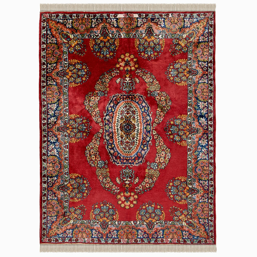 rug in deep red silk with oval floral medallion motif, demonstrating handwoven rug craftsmanship.