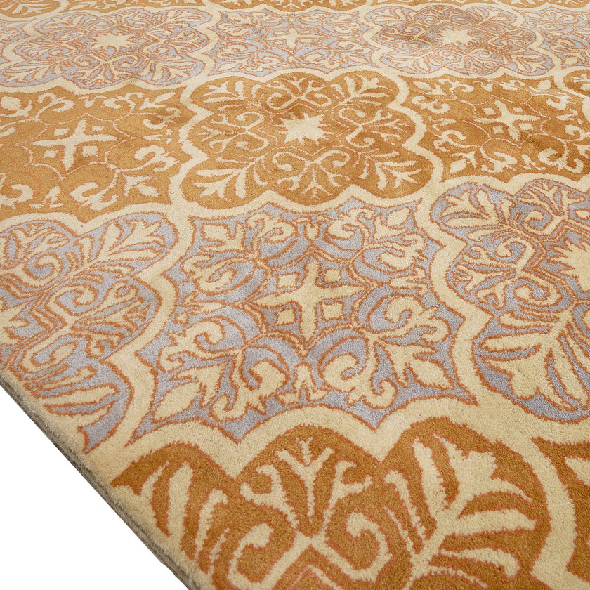 rug in lavender wool with floral/tile quatrefoil motif, demonstrating handwoven rug craftsmanship.