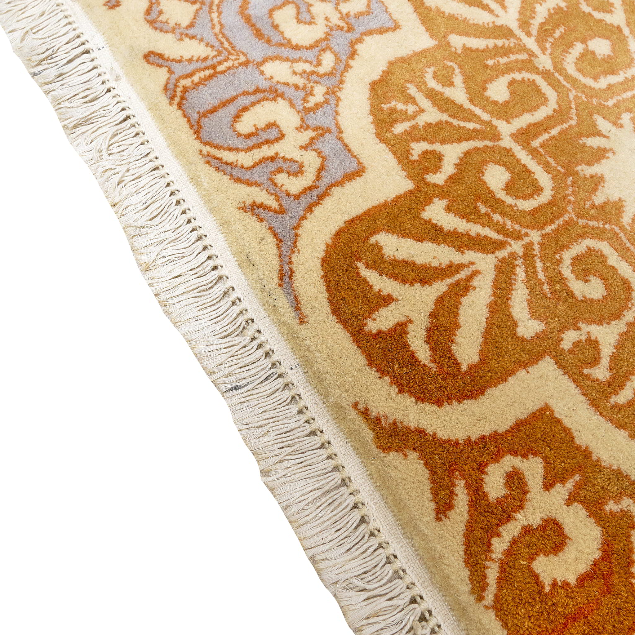 rug in lavender wool with floral/tile quatrefoil motif, demonstrating handwoven rug craftsmanship.