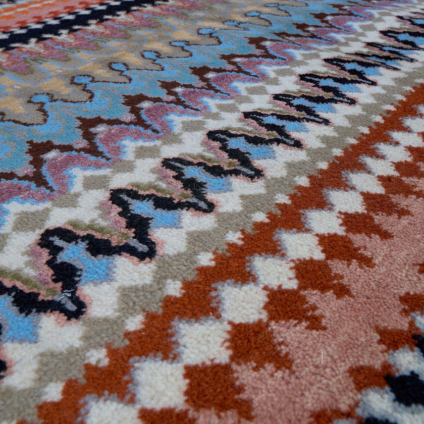 rug in blue wool with zigzag tribal stripe motif, demonstrating handwoven rug craftsmanship.
