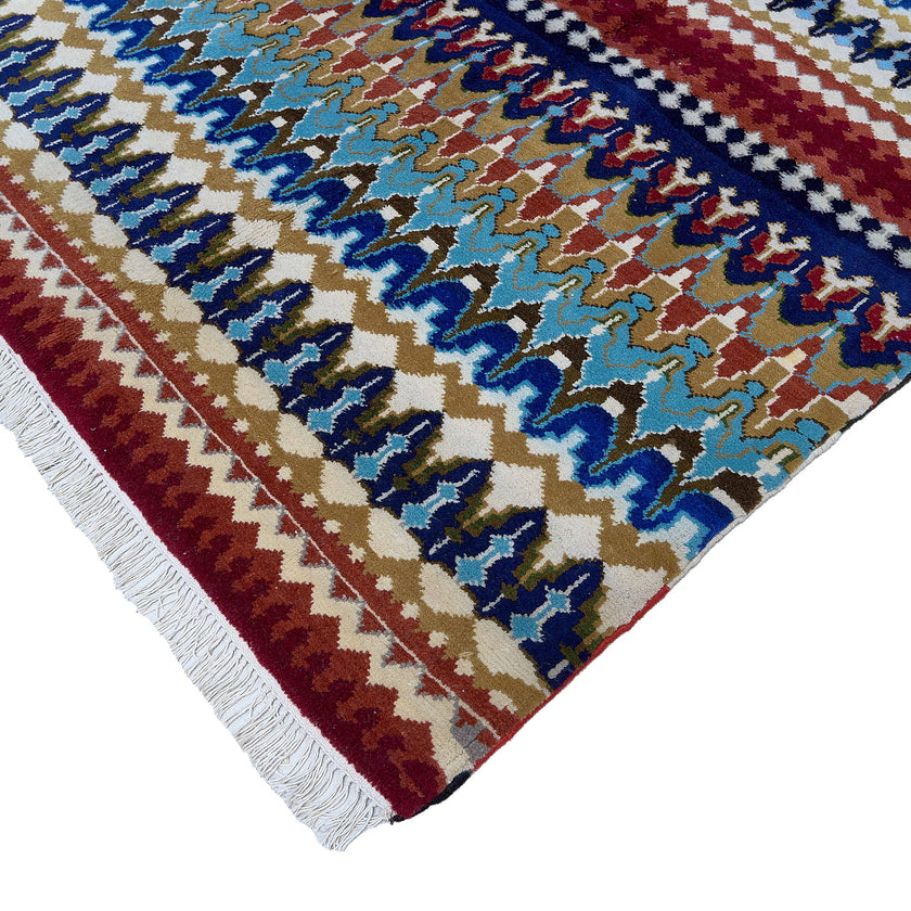 rug in navy wool with tribal striped wave motif, demonstrating handwoven rug craftsmanship.