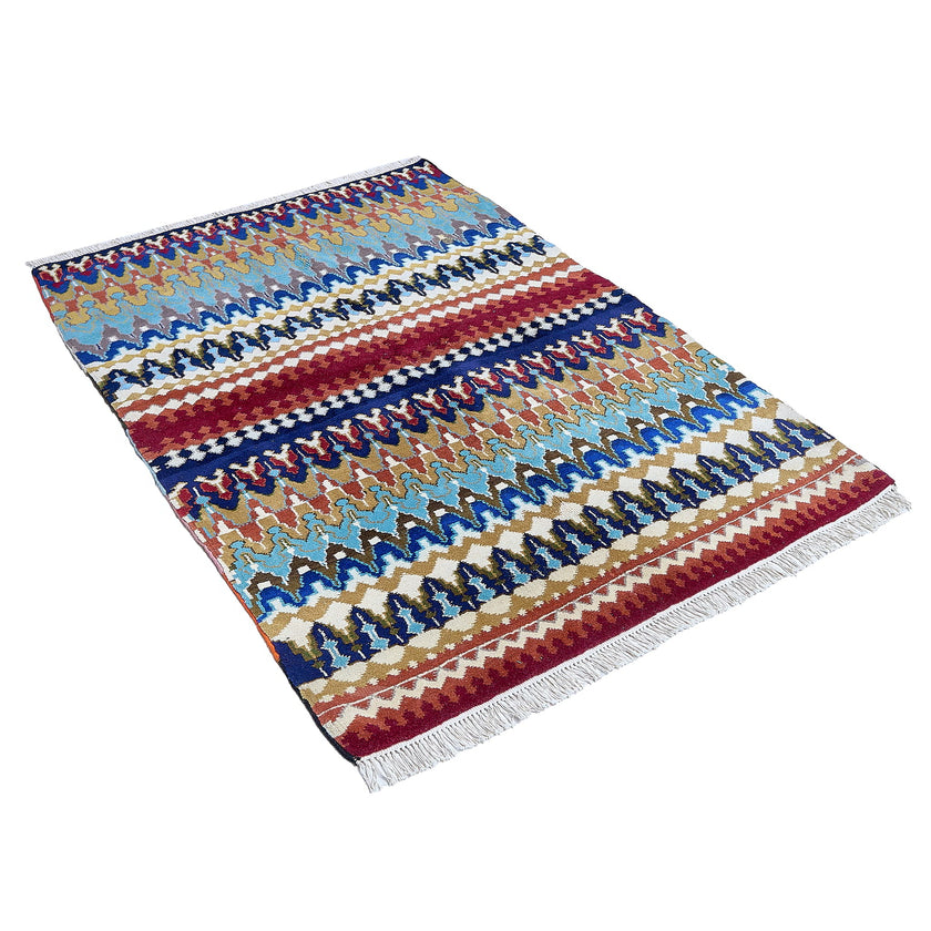 rug in navy wool with tribal striped wave motif, demonstrating handwoven rug craftsmanship.