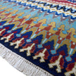 rug in navy wool with tribal striped wave motif, demonstrating handwoven rug craftsmanship.