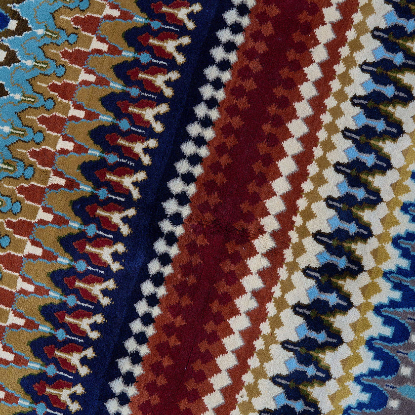 rug in navy wool with tribal striped wave motif, demonstrating handwoven rug craftsmanship.