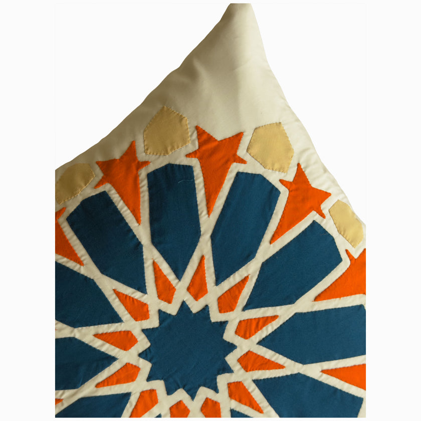 Cushion in petroleum and burnt orange polycotton with Najmi star geometry, demonstrating Khayamiya craftsmanship.