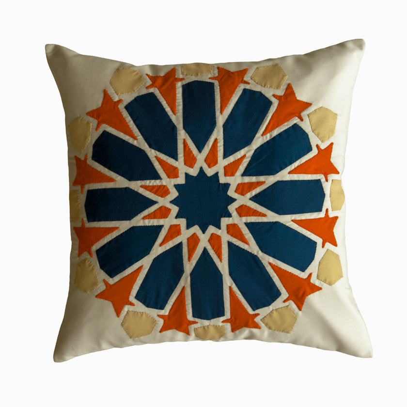 Cushion in petroleum and burnt orange polycotton with Najmi star geometry, demonstrating Khayamiya craftsmanship.