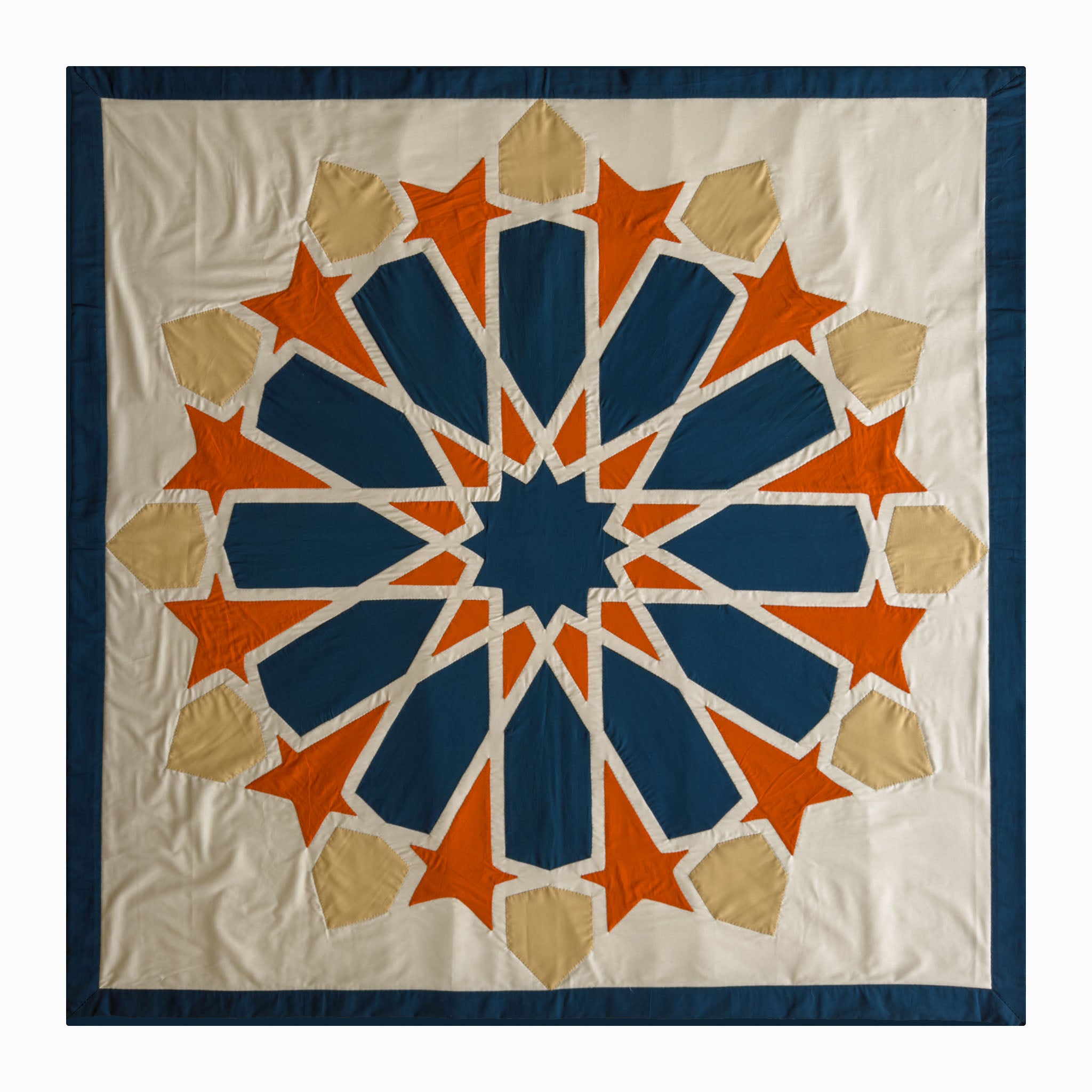 Square runner in petroleum and burnt orange polycotton with Najmi star geometry, demonstrating Khayamiya craftsmanship.