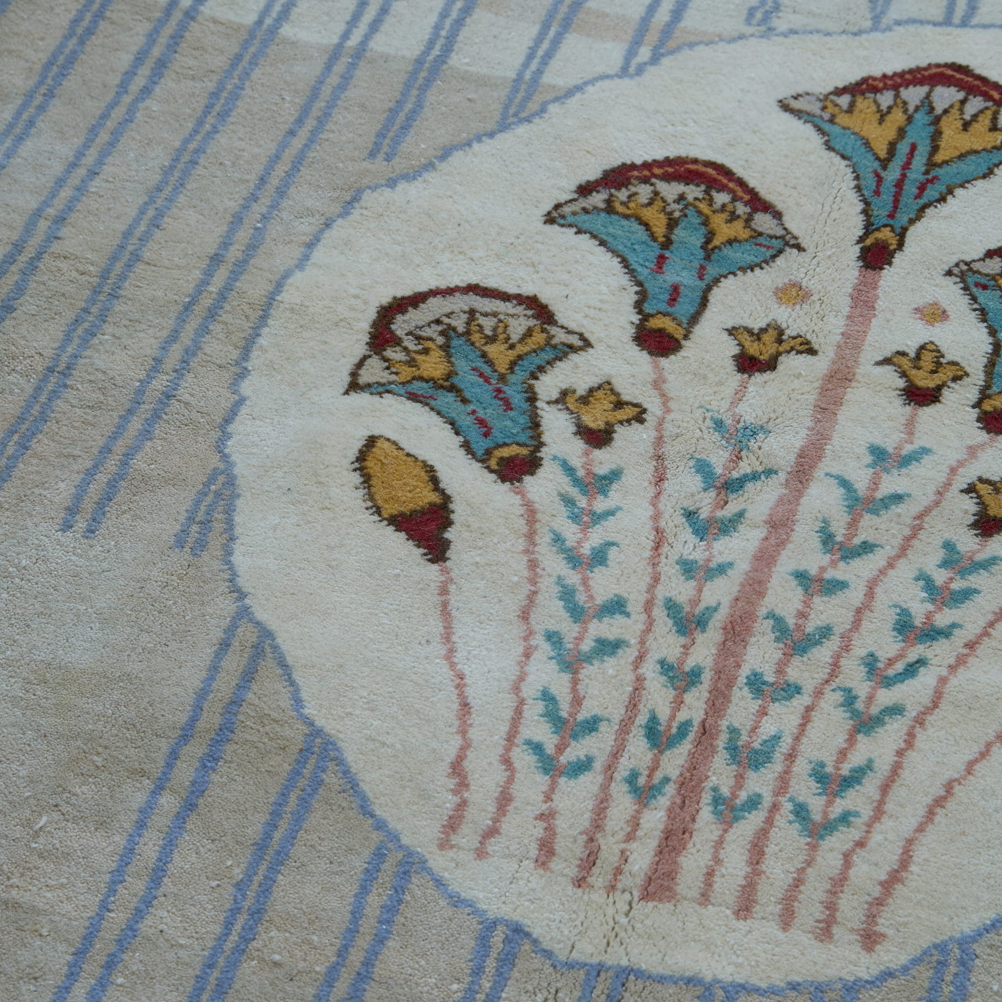 rug in brown wool with transitional floral motif, demonstrating handwoven rug craftsmanship.