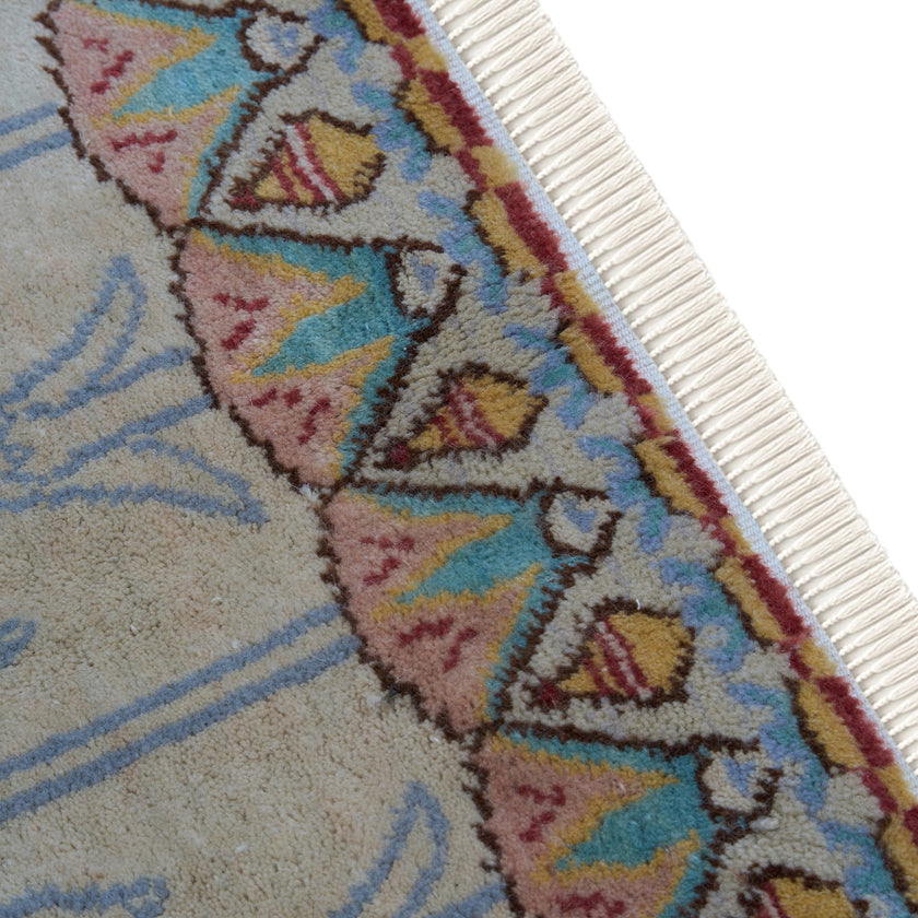 rug in brown wool with transitional floral motif, demonstrating handwoven rug craftsmanship.