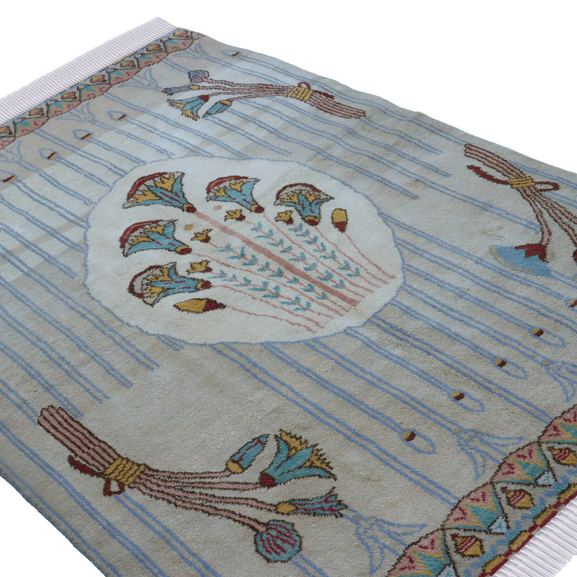 rug in brown wool with transitional floral motif, demonstrating handwoven rug craftsmanship.