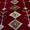 rug in deep red wool with diamond pathway motif, demonstrating handwoven rug craftsmanship.