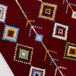 rug in deep red wool with diamond pathway motif, demonstrating handwoven rug craftsmanship.