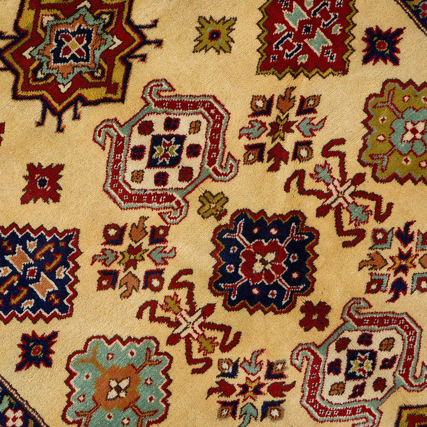 rug in red wool with star-based geometric motif, demonstrating handwoven rug craftsmanship.